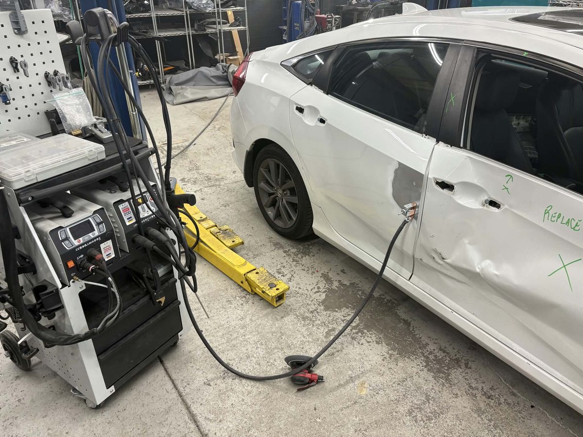 Southeast Collision Equipment spot-welding equipment set up beside a vehicle in a repair bay